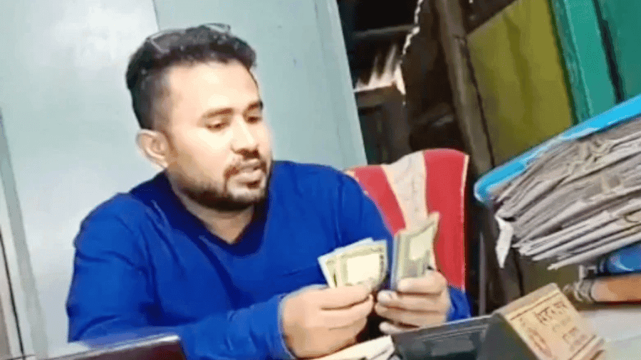 Video of counting bribe money goes viral, land official suspended