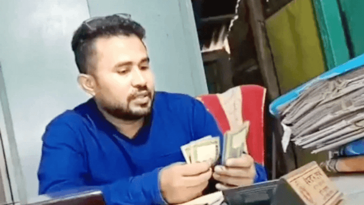 Video of counting bribe money goes viral, land official suspended