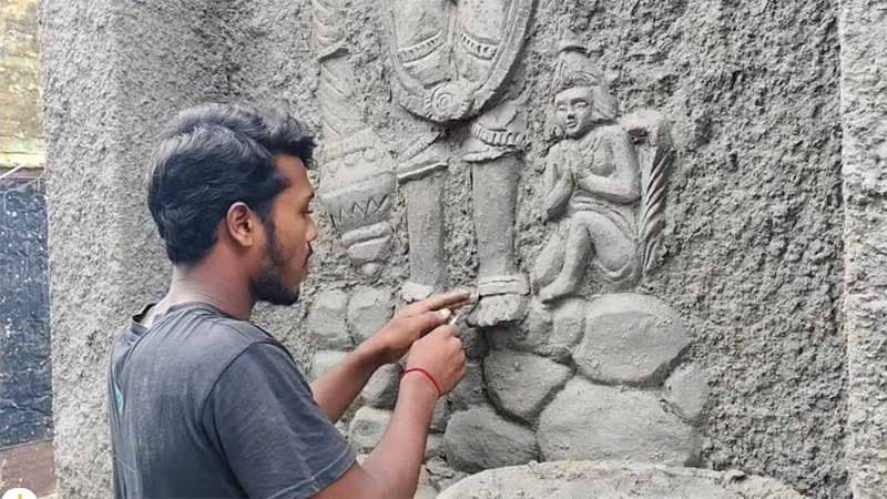 Bangladeshi youth decorating Durga Mandap in West Bengal