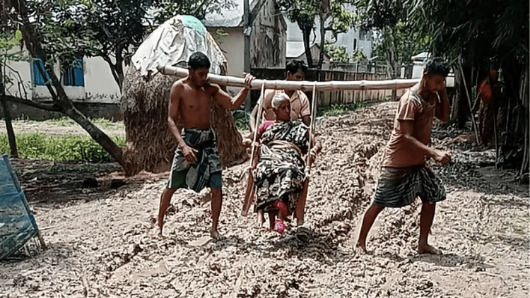 Sons carry mother through mud on bamboo chair to seek treatment