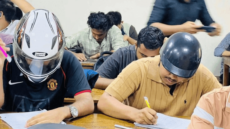 JnU students attends exam wearing helmets for ceiling collapse fear