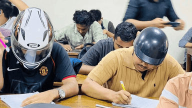 JnU students attends exam wearing helmets for ceiling collapse fear