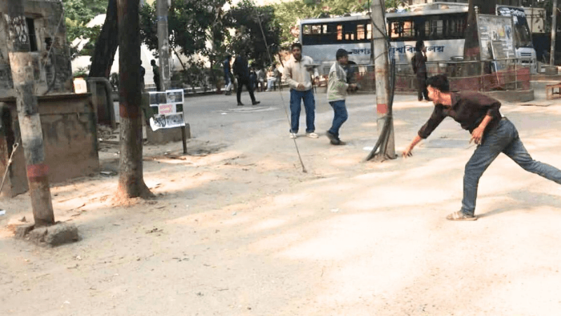 Students throw shoes at symbolic images of Razakars at Jagannath University